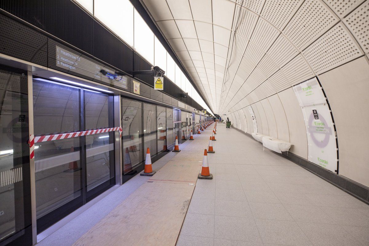 Farringdon station with ghost shadows (or blast shadows) visible behind the station's seats in June 2019. The seats are clearly seen covered up but at various points in time they were uncovered and used by construction workers. The station platform surfaces are not finished and there is a certain amount of work still to do.