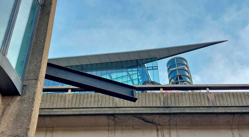 Looking up form the adjacent service road one can see examples of a modernist ship's prow from 1968 and another from c2015. Its interesting the 1968 design has influenced the later Paddington central development!