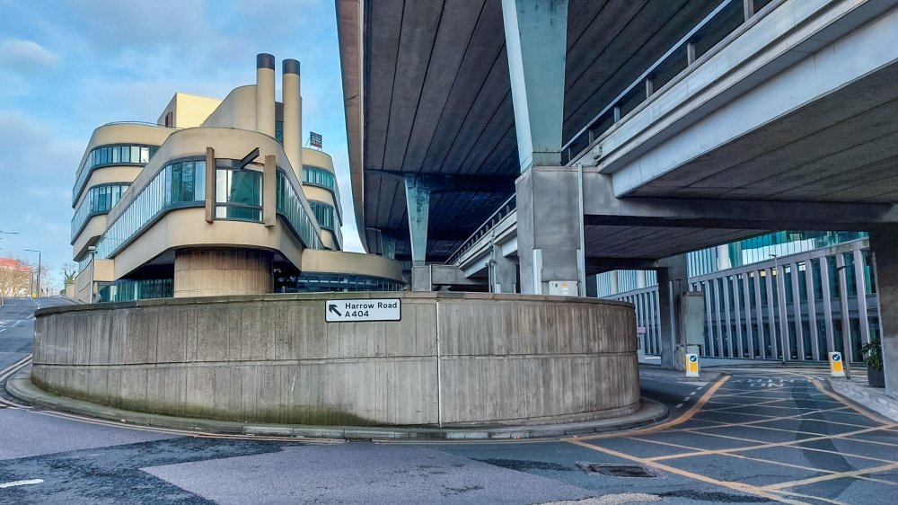 The best view of the premises happens to be at the rear where its ship like appearance becomes quite obvious. The Westway forms a monstrous construction right next to the Battleship building. A sign saying Harrow Road A404 can be seen.