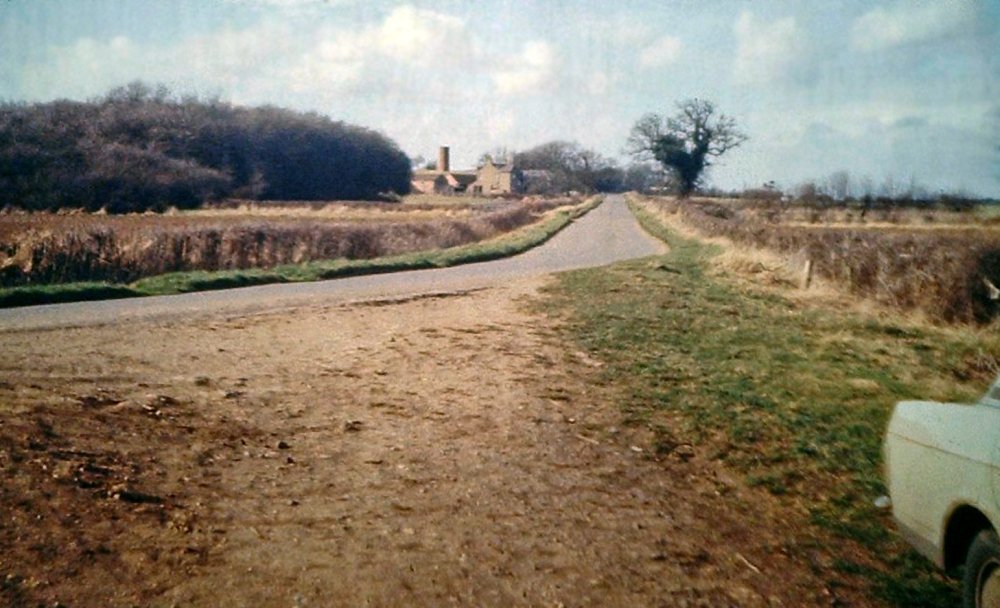 View from the route of the old boat horse path showing the of the B class road and the farmhouses that can be sighted just before the air shaft belonging to the canal tunnel.