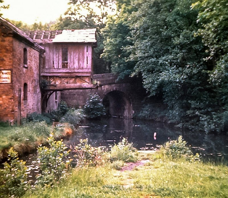 Author's photograph of the canal wharf and warehouse at Froghall taken on a visit in 1977. The canal is open but is hardly used because of the diminutive tunnel boats need to get through. The warehouse is in a derelict condition and parts of its roof is missing.