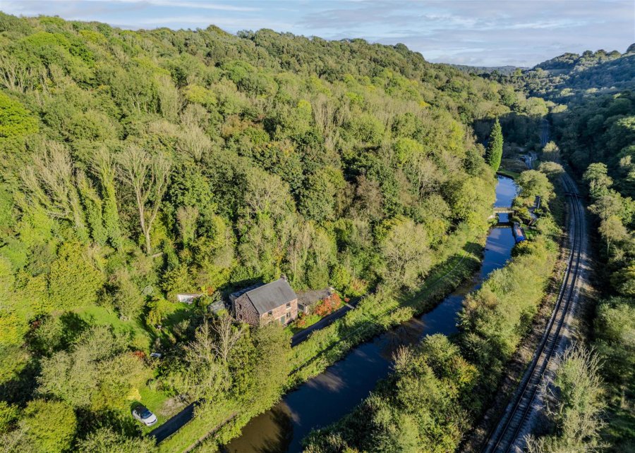 Aerial view of the Churnet valley showing the canal as it winds its way to Froghall. The railway can be seen at right. The hills are evident in this view with their beautifully covered woodland slopes.