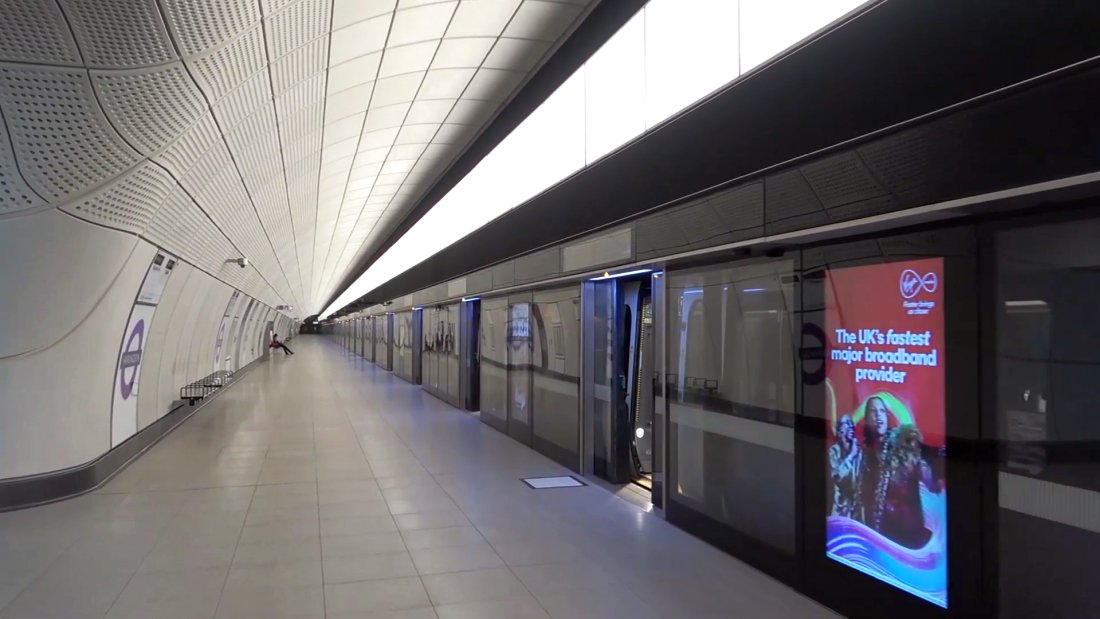 Farringdon station with ghost shadows (or blast shadows) visible behind the station's seats in June 2022. There's just one passenger in this view of the long station platforms at Farringdon!