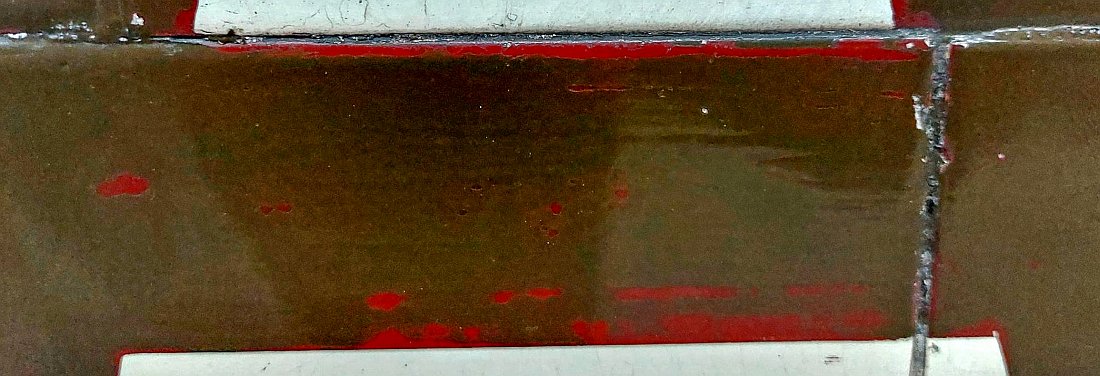 Close up of the letters depicting Great Central (Marylebone) showing the previous colours on the tiles. The brown covers what was previously the maroon appearance of these letters and traces of that colour can be seen.