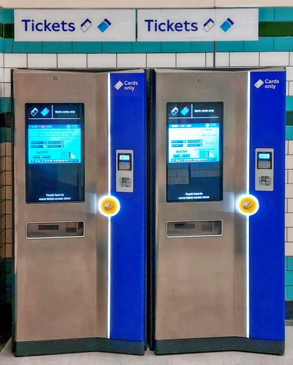 Signs read 'Tickets' and below these can be seen two new ticket machines. On these it says 'Cards only.' The machines are of the latest design - a touch screen, a card reader and a ticket dispensing tray.