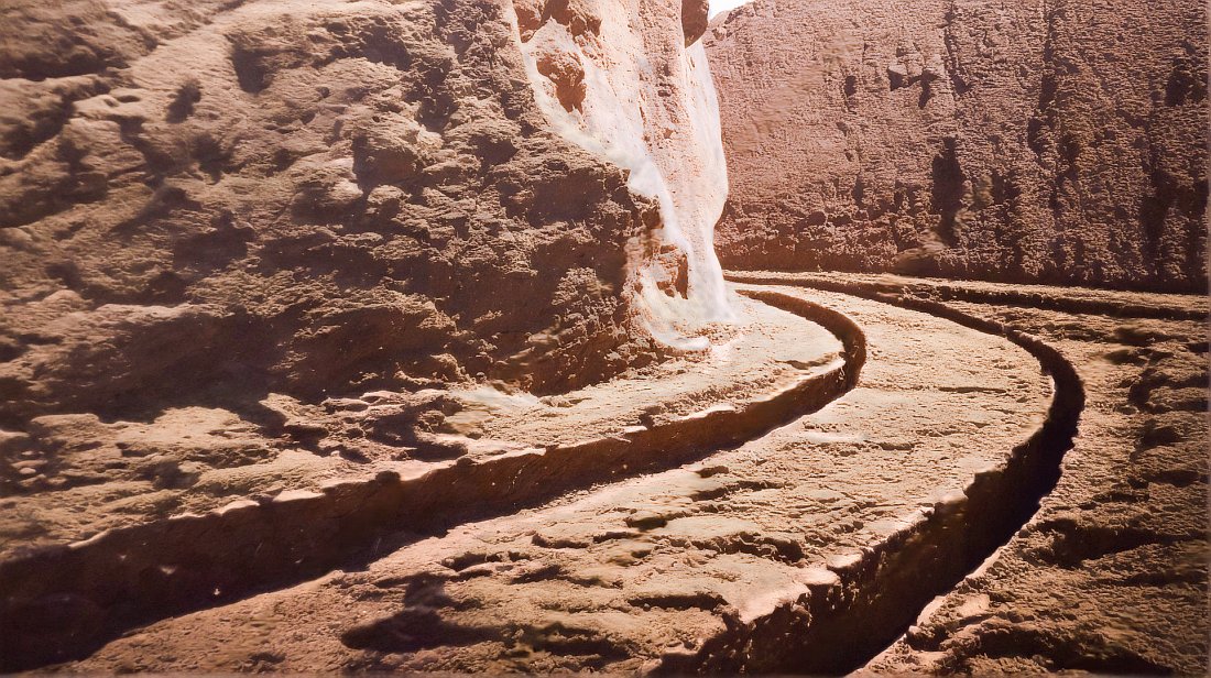Image taken probably end of 19th century showing a Roman road in Syracuse. What can be seen is a pair of deep tracks curving around a cliff face to join another. Much of the area is rocky ground, not a lot of features here really.