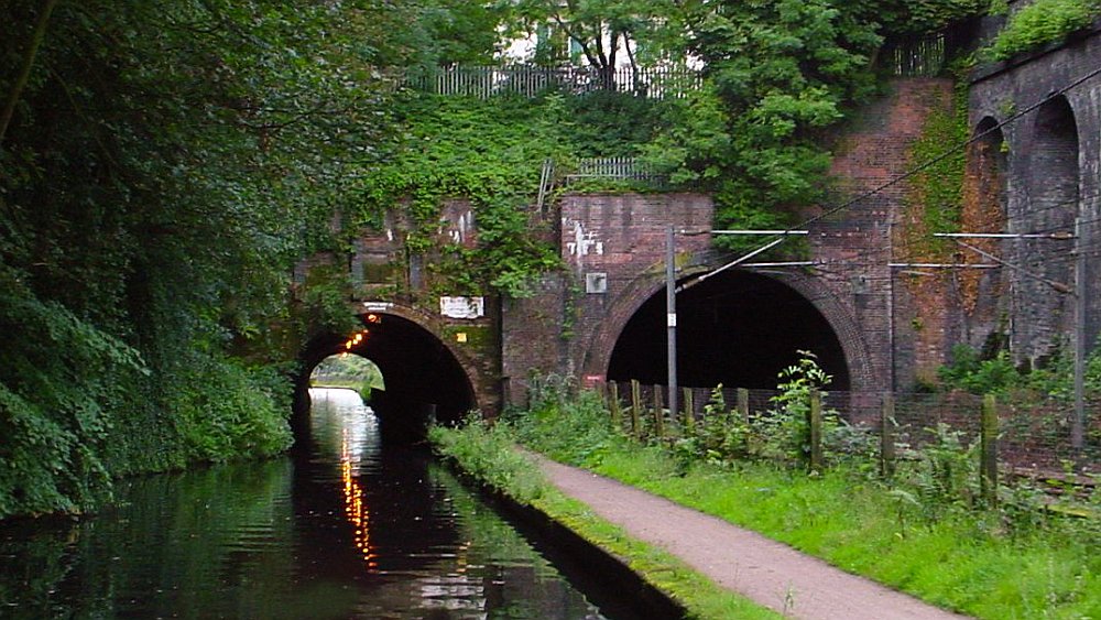 View of the twin tunnels at Edgbaston. On the left is the canal tunnel and on the right is the electrified railway tunnel. The canal towpath forms a division in the middle between the two.