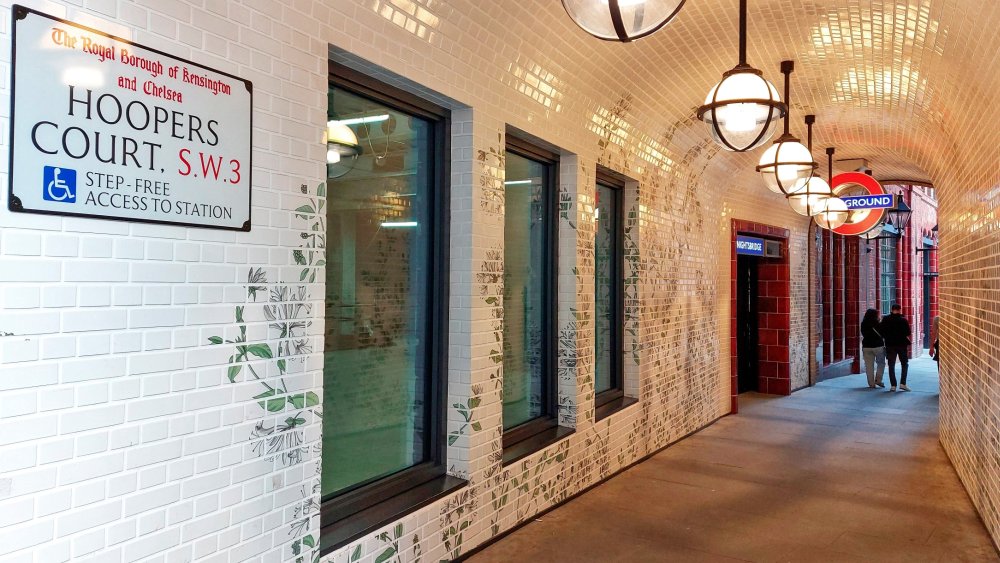The Hoopers Court entrance off Brompton Road with the new tube station entrance and its roundel evident. The passageway is nicely decorated by flowers and other green leaves. IT also has three windows that will form part of a new shop unit that is yet to open.
