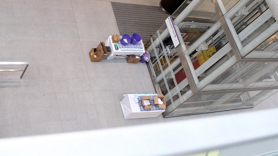 View of the ticket hall level at Paddington Elizabeth line showing the lifts and a pair of tables that had booklets on the Elizabeth line ready for the hordes of trial run participants who would soon arrive at the station.